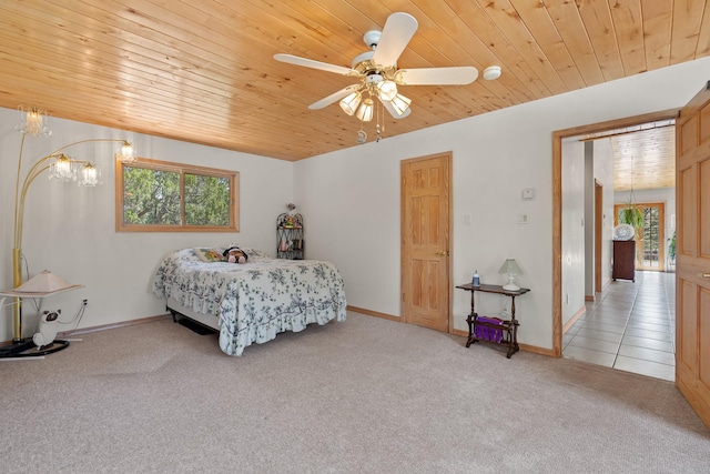 71 Apache Plume Dr, Santa Fe, NM 87508 - bedroom featuring wood ceiling, light carpet, baseboards, ceiling fan, and a chandelier