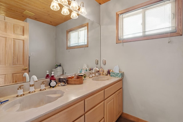 71 Apache Plume Dr, Santa Fe, NM 87508 - bathroom with double vanity and a chandelier