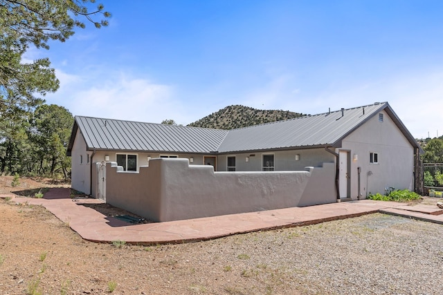 71 Apache Plume Dr, Santa Fe, NM 87508 - rear view of property featuring stucco siding and metal roof