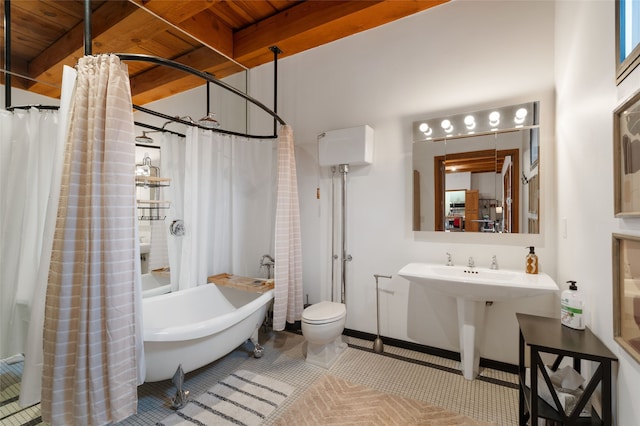 749 Alto St Unit A, Santa Fe, NM 87501 - bathroom featuring toilet, wood ceiling with exposed beams, and tile patterned flooring