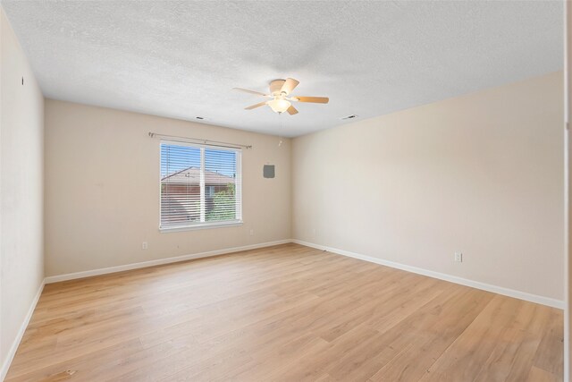 2613 Camino Catalonia, Rio Rancho, NM 87124 - spare room with a ceiling fan, light wood-type flooring, a textured ceiling, and baseboards