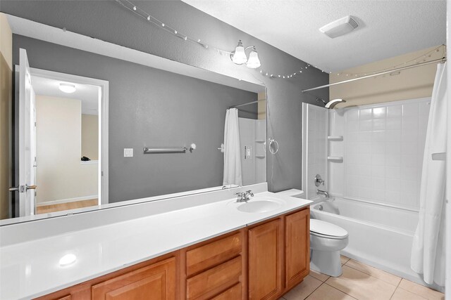 2613 Camino Catalonia, Rio Rancho, NM 87124 - full bathroom with toilet, shower / tub combo with curtain, vanity, tile patterned floors, and a textured ceiling