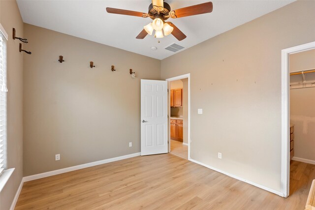 2613 Camino Catalonia, Rio Rancho, NM 87124 - unfurnished bedroom with a spacious closet, light wood-type flooring, baseboards, a closet, and a ceiling fan