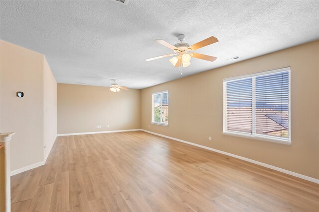 2613 Camino Catalonia, Rio Rancho, NM 87124 - spare room featuring ceiling fan, light wood-style flooring, baseboards, and a textured ceiling