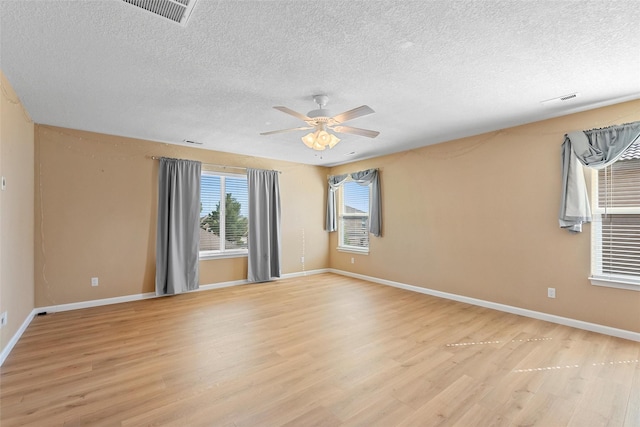 2613 Camino Catalonia, Rio Rancho, NM 87124 - spare room with a textured ceiling, light wood finished floors, ceiling fan, and baseboards