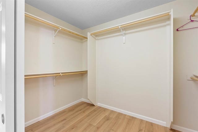 2613 Camino Catalonia, Rio Rancho, NM 87124 - walk in closet featuring wood finished floors