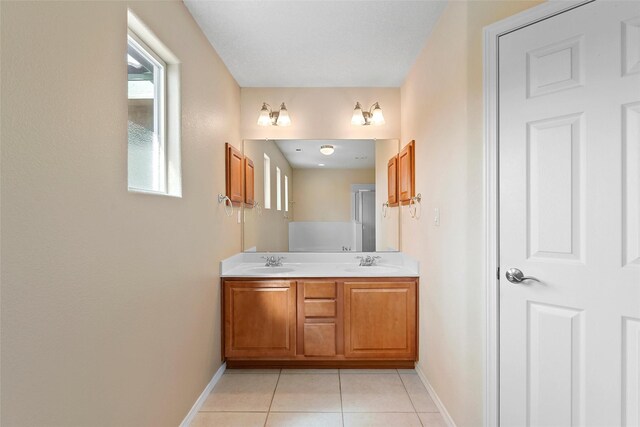 2613 Camino Catalonia, Rio Rancho, NM 87124 - full bathroom with baseboards, tile patterned flooring, and double vanity