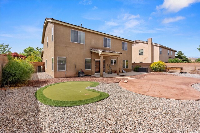 2613 Camino Catalonia, Rio Rancho, NM 87124 - rear view of property featuring a putting green, a patio area, stucco siding, a pergola, and cooling unit