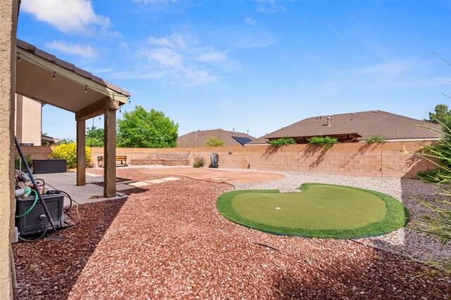 2613 Camino Catalonia, Rio Rancho, NM 87124 - fenced backyard with a patio, a putting area, and central AC