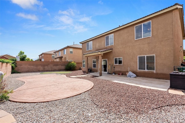 2613 Camino Catalonia, Rio Rancho, NM 87124 - back of house with stucco siding, a patio, and a fenced backyard