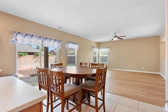 2613 Camino Catalonia, Rio Rancho, NM 87124 - dining room featuring a ceiling fan, light tile patterned flooring, baseboards, and a textured ceiling