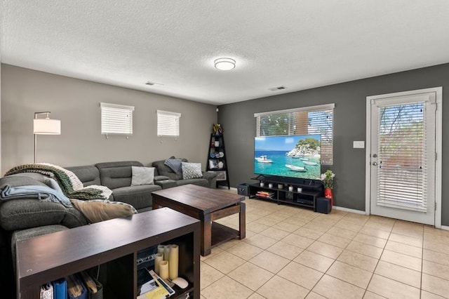 6280 Nardos Rd NW, Albuquerque, NM 87114 - living area with light tile patterned floors, a textured ceiling, and baseboards