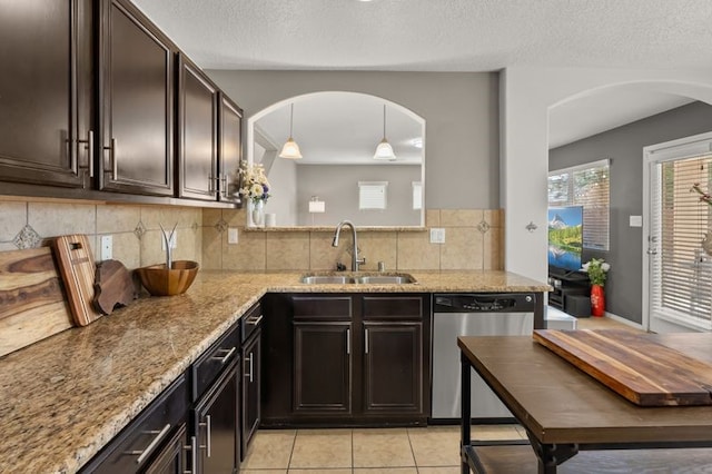 6280 Nardos Rd NW, Albuquerque, NM 87114 - kitchen featuring stainless steel dishwasher, a sink, light stone countertops, backsplash, and light tile patterned floors