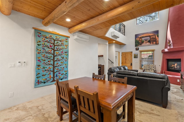 505 Juniper Dr Unit B, Santa Fe, NM 87501 - dining space featuring a large fireplace, wooden ceiling with exposed beams, a wall mounted AC, light stone finish floors, and recessed lighting