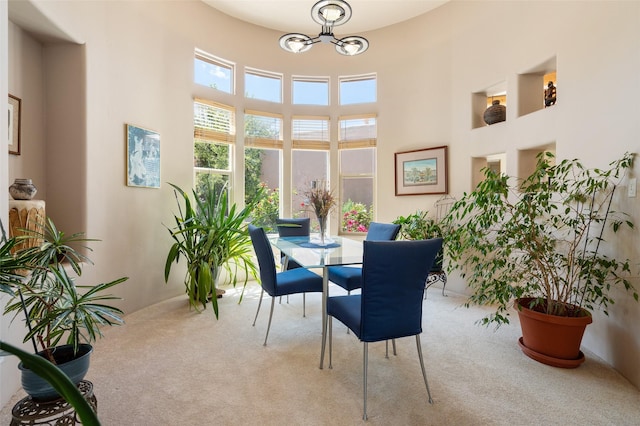 15 Cimarron Pass, Santa Fe, NM 87508 - carpeted dining area featuring a chandelier and a towering ceiling