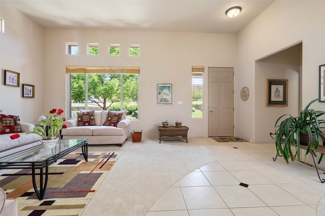 15 Cimarron Pass, Santa Fe, NM 87508 - living room with healthy amount of natural light, light tile patterned flooring, and a towering ceiling
