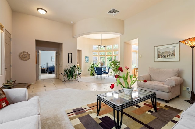 15 Cimarron Pass, Santa Fe, NM 87508 - living area with light tile patterned floors, a chandelier, light carpet, and arched walkways