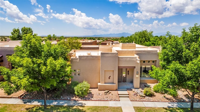 15 Cimarron Pass, Santa Fe, NM 87508 - pueblo revival-style home with stucco siding