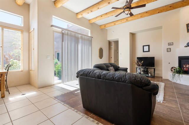 15 Cimarron Pass, Santa Fe, NM 87508 - living room featuring a towering ceiling, a ceiling fan, beamed ceiling, healthy amount of natural light, and tile patterned floors