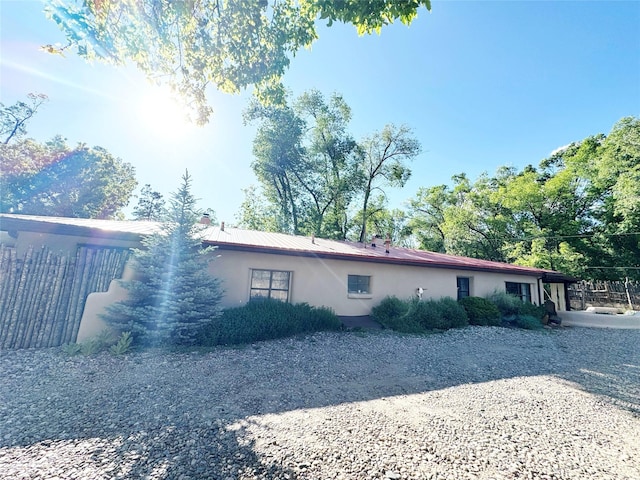 1402A Bishops Lodge Rd, Santa Fe, NM 87506 - view of home's exterior with stucco siding and a chimney