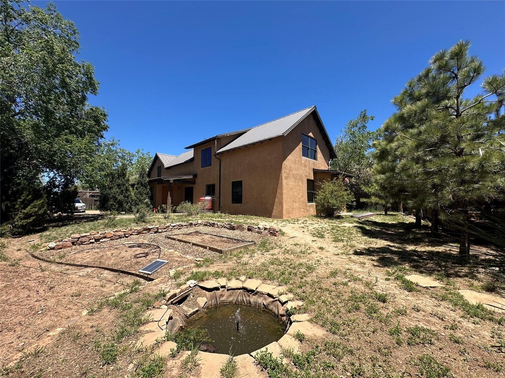 1616 Jay St, Santa Fe, NM 87505 - view of home's exterior with stucco siding and metal roof