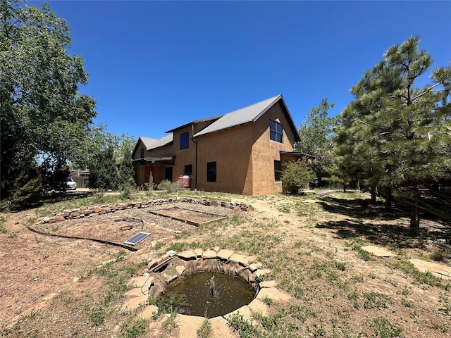 1616 Jay St, Santa Fe, NM 87505 - view of home's exterior with stucco siding and metal roof