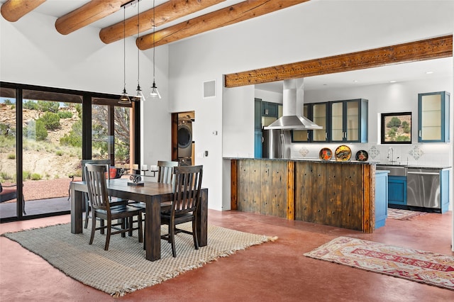 681 General Goodwin Rd, Cerrillos, NM 87010 - dining room featuring a high ceiling, stacked washer / dryer, beamed ceiling, healthy amount of natural light, and recessed lighting