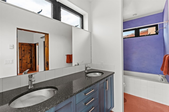 681 General Goodwin Rd, Cerrillos, NM 87010 - full bathroom featuring toilet, healthy amount of natural light, double vanity, and tiled bath