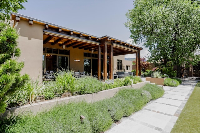 974 Old Santa Fe Trl, Santa Fe, NM 87505 - rear view of house featuring stucco siding and a patio area