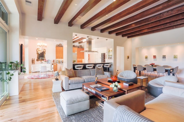 974 Old Santa Fe Trl, Santa Fe, NM 87505 - living area featuring light wood-type flooring, a chandelier, and beam ceiling