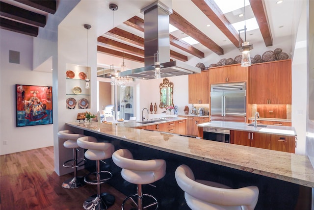 974 Old Santa Fe Trl, Santa Fe, NM 87505 - kitchen featuring stainless steel built in refrigerator, island exhaust hood, beam ceiling, wood finished floors, and light stone counters