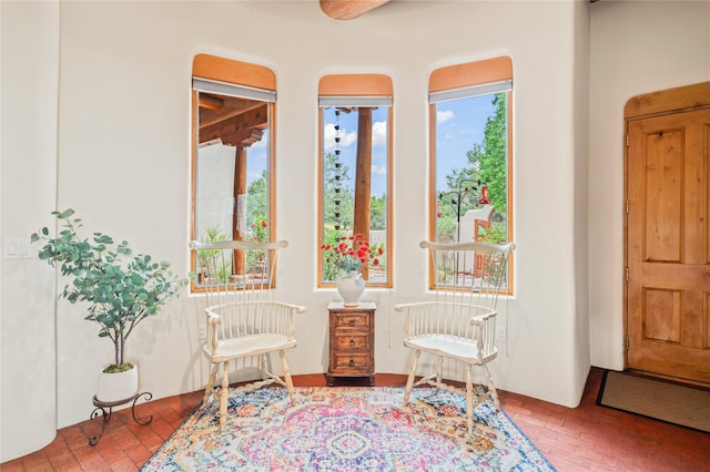 17 Alteza, Santa Fe, NM 87508 - sitting room featuring brick flooring and plenty of natural light