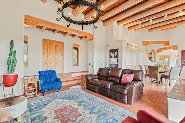 17 Alteza, Santa Fe, NM 87508 - living room featuring a chandelier, beamed ceiling, and brick floors
