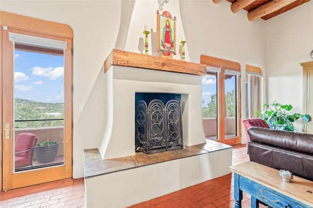 17 Alteza, Santa Fe, NM 87508 - living area with a high ceiling, beam ceiling, and brick patterned floors