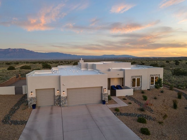 2324 Venada Rd, Rio Rancho, NM 87144 - southwest-style home with a garage, a mountain view, stucco siding, and concrete driveway
