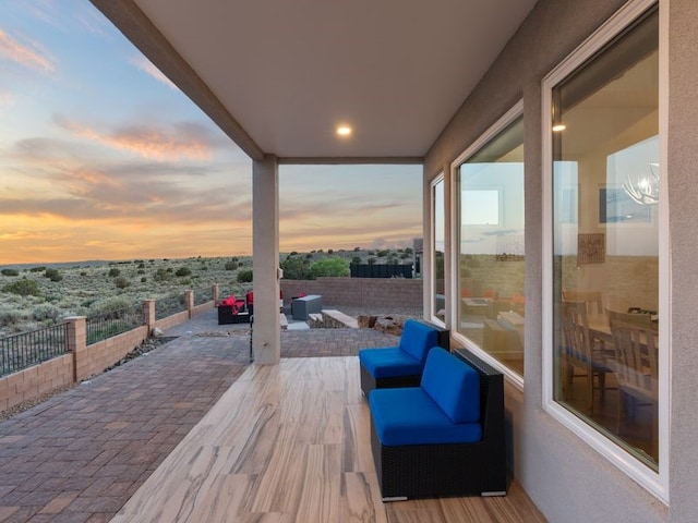 2324 Venada Rd, Rio Rancho, NM 87144 - deck at dusk featuring a patio area and an outdoor living space