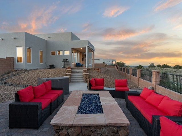 2324 Venada Rd, Rio Rancho, NM 87144 - patio terrace at dusk featuring an outdoor living space with a fire pit and a patio