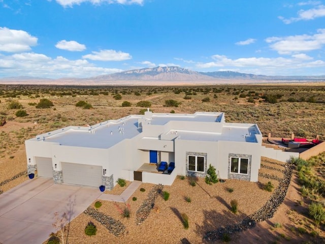 2324 Venada Rd, Rio Rancho, NM 87144 - view of front of house featuring view of desert, a mountain view, stucco siding, and an attached garage