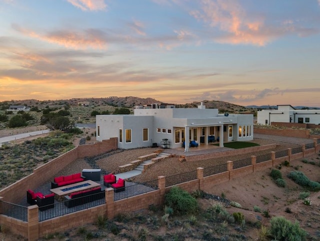 2324 Venada Rd, Rio Rancho, NM 87144 - rear view of property with a patio, a fenced backyard, an outdoor living space, stucco siding, and a chimney