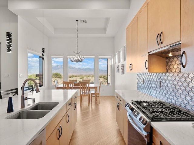 2324 Venada Rd, Rio Rancho, NM 87144 - kitchen featuring stainless steel gas range, light brown cabinetry, a tray ceiling, and under cabinet range hood
