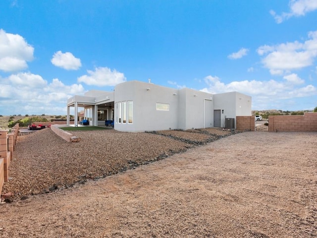2324 Venada Rd, Rio Rancho, NM 87144 - back of property with a gate and stucco siding