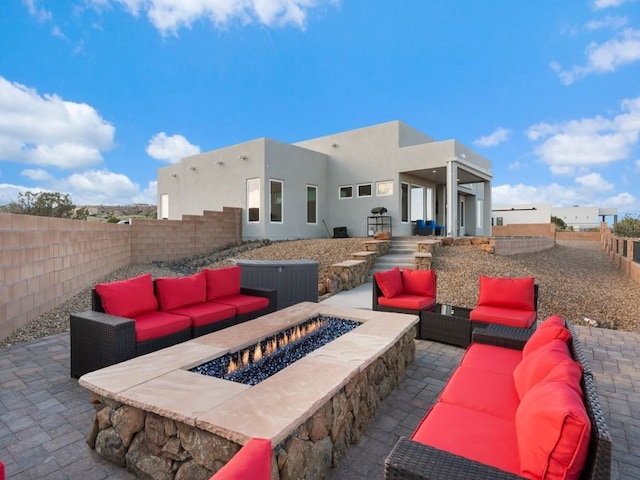 2324 Venada Rd, Rio Rancho, NM 87144 - fenced backyard featuring an outdoor living space with a fire pit and a patio area