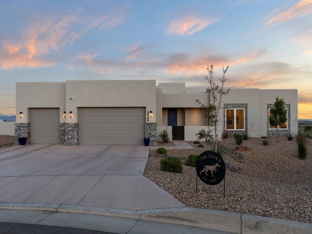 2324 Venada Rd, Rio Rancho, NM 87144 - southwest-style home with an attached garage, stucco siding, driveway, and stone siding