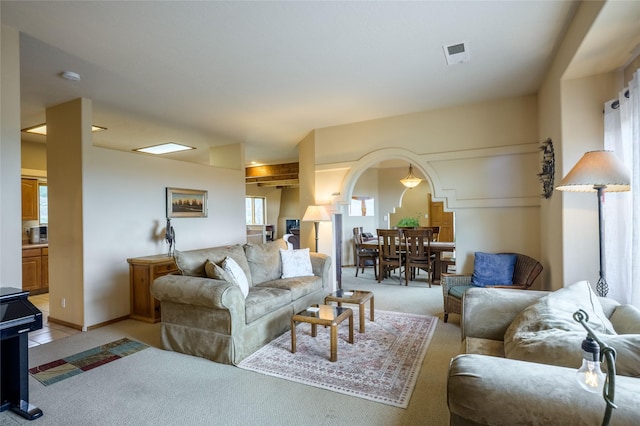 131 Quintana Rd, Questa, NM 87556 - living area with light carpet and arched walkways