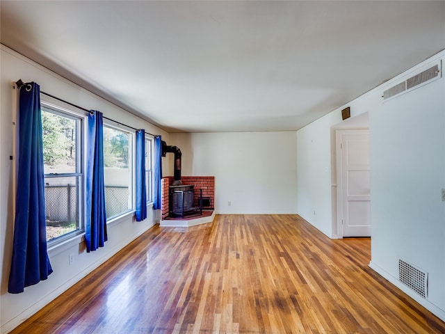 2148 33rd St Unit B, Los Alamos, NM 87544 - unfurnished living room featuring a wood stove and hardwood / wood-style flooring