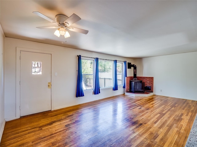 2148 33rd St Unit B, Los Alamos, NM 87544 - unfurnished living room with a wood stove, wood finished floors, and a ceiling fan