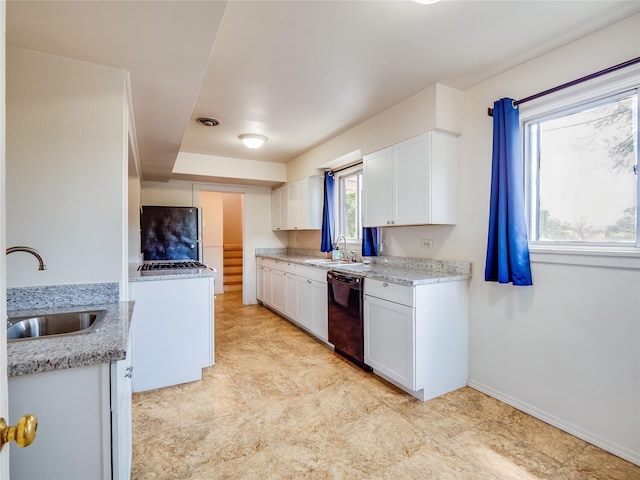 2148 33rd St Unit B, Los Alamos, NM 87544 - kitchen with dishwasher, white cabinets, freestanding refrigerator, and light stone counters
