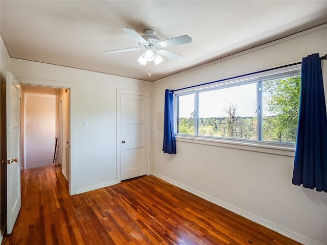 2148 33rd St Unit B, Los Alamos, NM 87544 - unfurnished bedroom featuring dark wood finished floors, a closet, and a ceiling fan