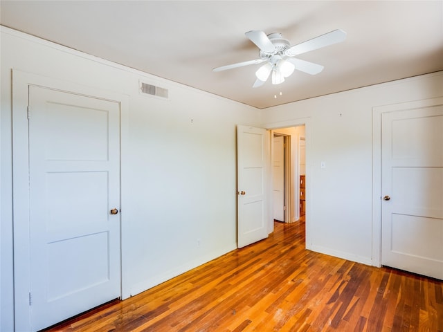 2148 33rd St Unit B, Los Alamos, NM 87544 - unfurnished bedroom featuring wood finished floors and ceiling fan