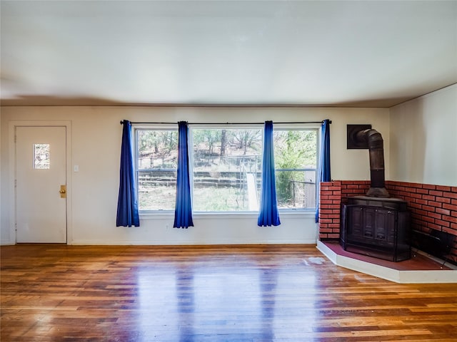 2148 33rd St Unit B, Los Alamos, NM 87544 - unfurnished living room featuring a wood stove and wood finished floors